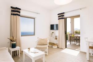 a living room with a couch and a table at Villa Stella Suites in Plakias