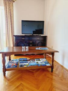 a coffee table in a living room with a tv at Guest House Sombrero in Senj