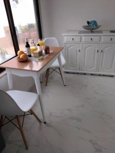 a kitchen with a table with fruit and drinks on it at JB House in Nazaré