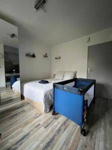 a bedroom with a bed and a blue dresser at DnN - Stylish Studio, 2 peoples- WiFi, Netflix, parking - min away to Basel and Airport - dishwasher, washing machine in Saint-Louis