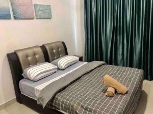 a bed with a pillow on it in a bedroom at Sandy Beach Living near Desaru in Bandar Penawar