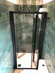 a glass shower with a baseball bat on the floor at The Old Bakery, NEC, BHX, HS2, Birmingham in Birmingham