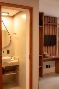 a bathroom with a sink and a mirror at Vila Diamantina in Mucugê