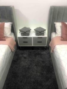 two beds sitting next to each other in a room at The Old Bakery, NEC, BHX, HS2, Birmingham in Birmingham