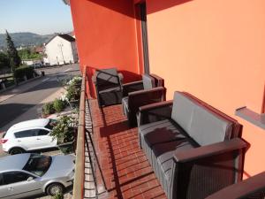 a balcony with chairs and tables on a building at Chez Jpzen Nowicki in Freyming