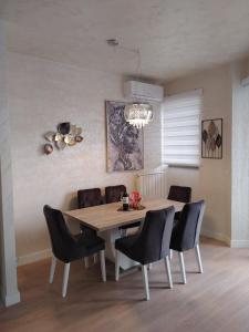 a dining room with a table and chairs at GIGI Apartment in Belgrade
