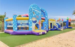 a inflatable playground with a water park on the beach at Stunning Caravan In Hyres With Wifi And 3 Bedrooms in Hyères