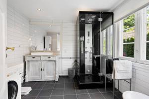 a bathroom with a shower and a sink at Leilighet på Smestad in Oslo