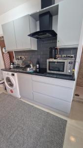 a kitchen with a counter top with a microwave at SMALL COZY STUDIO ZONE 1 LONDON in London