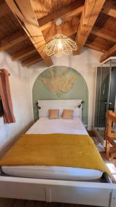a bedroom with a large bed in a room at maisonnette avec jardin et terrasse in Montdardier