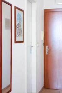 a hallway with a door and a picture and a mirror at Apartment Tonka-Riva in Split