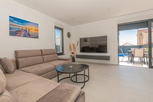 a living room with a couch and a table at Villa Katarina Vodice in Vodice