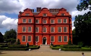 a large red brick building with a large doorway at En-suite luxury large bedroom with parking and two tickets to Kew Gardens in Kew Gardens