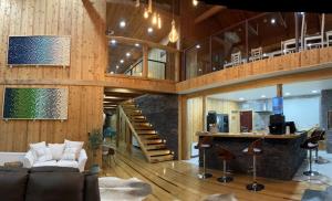 a living room with wood paneling and a staircase at PARCELA DE AGRADO CON PISCINA LAGO RANCO todas las instalaciones con uso exclusivo capacidad 20 personas in Lago Ranco