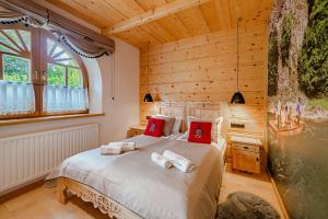 a bedroom with a bed with towels on it at Rezydencja Pod Sadami in Szczawnica