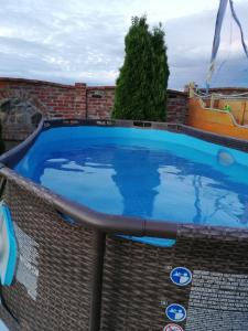 a large blue swimming pool on top of a building at Baltic-House in Gąski