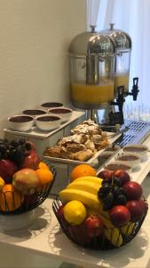 a counter with two baskets of fruit and a mixer at Hotel Villa Gracia in Budva
