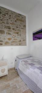 AmbraにあるVilla Elviraの石壁のベッドルーム1室(ベッド1台付)