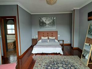 1 dormitorio con cama y alfombra en Casa Chalet, Villa Elisa, en Gijón