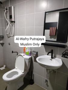 a bathroom with a toilet and a sink at AL-WAFRY PUTRAJAYA Presint 16 - Bersebelahan Everly Alamanda Mall in Putrajaya