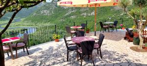 a group of tables and chairs sitting on a patio at Rooms Dujeva Drago-Resort in Rijeka Crnojevića