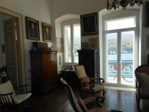 a living room with chairs and a large window at Mansion at Chora in Andros in Andros