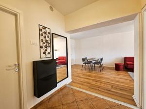 a dining room with a table and a mirror at Apartment Mari in Zadar