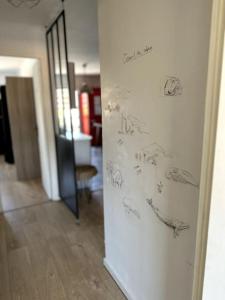 a refrigerator with drawings on it in a hallway at Appartement Cosy Calao - Parking fermé gratuit in Perpignan