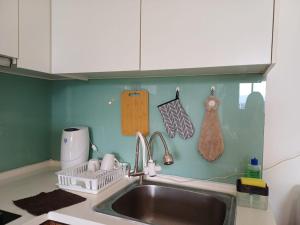 a kitchen counter with a sink and a sink at Mansion One Seaview 2Bedroom 2Bathroom Georgetown Gleneagles Penang By AmrayHomes in George Town +30 photos