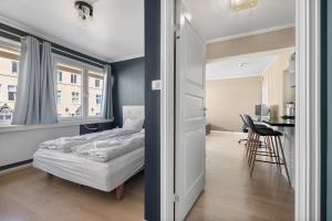 a bedroom with a bed and a table in a room at 2 min to Bryggen - Rooftop - Office with 49" Screen in Bergen