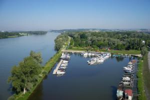 
boats are docked at a dock in the water at Camping & Pension Au an der Donau in Au an der Donau
