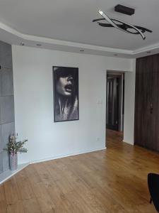 a room with a black and white photo on the wall at Apartament nad jeziorem Sport i Rekreacja in Ełk