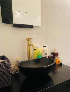a black bowl on a counter in a kitchen at Private Room Studio Suite Jerusalem in Jerusalem