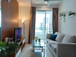 uma sala de estar com um sofá e uma televisão em Mansion One Seaview 2Bedroom 2Bathroom Georgetown Gleneagles Penang By AmrayHomes em George Town