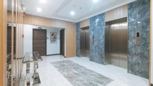 a lobby with elevators in a building at RedDoorz Plus @ Bez Tower and Residences San Juan in Manila