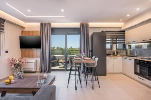a kitchen and living room with a table and chairs at Aspect Luxury Apartment I in Galangádhos