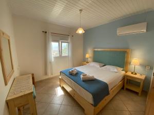 a bedroom with a bed with a teddy bear on it at Vaia Villas in Mochlos