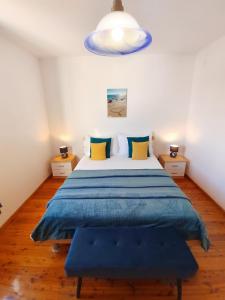 a bedroom with a large bed with a blue blanket at Apartments Marina in Hvar