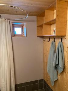 a bathroom with a shower curtain and a window at Edvardbua in Kvalnes