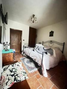 a bedroom with a bed and a tile floor at Il Borgo della Zittola in Montenero Val Cocchiara