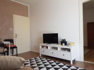 a living room with a tv on a white cabinet at Apartments Grković Trsteno Adventure Experience Accommodation 1 in Dubrovnik +3 photos
