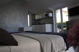 a bedroom with a large bed and a window at Apartments Grković Trsteno Adventure Experience Accommodation 1 in Dubrovnik