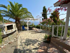 a patio with a bench and a view of the ocean at Vaia Villas in Mochlos
