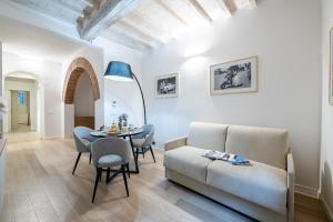 a living room with a couch and a table at Fiordaliso Boutique Apartments in Florence
