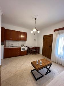 a living room with a table and a kitchen at Nisos family apartments in Yénion