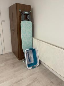 a suitcase is leaning against a wall next to a door at The Crescent, Flat 1 - Stockport, Manchester in Manchester