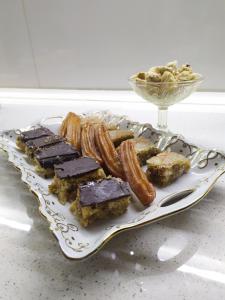 a plate of food with chocolate and pastries on it at Ali Ancient House 555 in Sheki