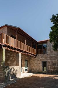 an outside view of a building with a deck at Casa Amorim Girão in Fataunços