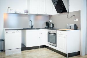 a kitchen with white cabinets and a sink at Modernes Apartment in Sulz am Neckar