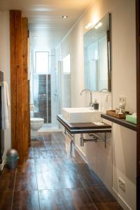 a bathroom with a sink and a toilet at Modernes Apartment in Sulz am Neckar